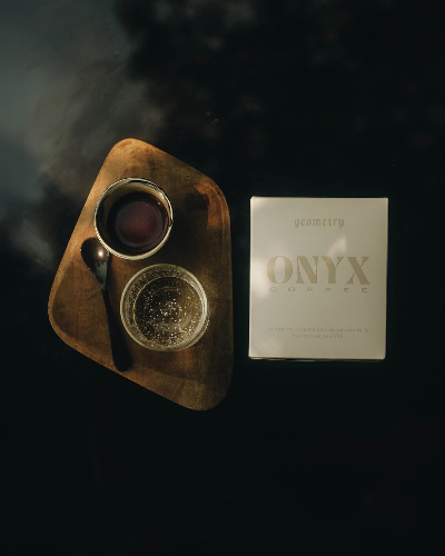 Onyx Coffee Lab Geometry box beside a cup of coffee