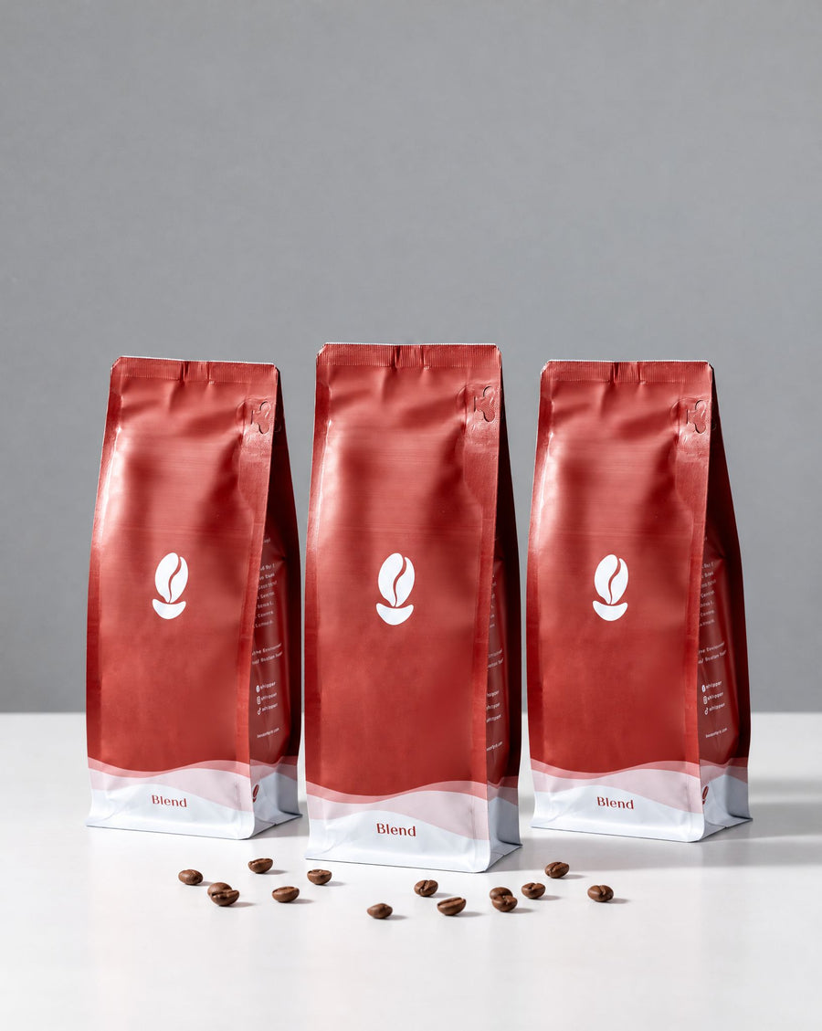 The Trio: three red Bean Shipper bags on a white table