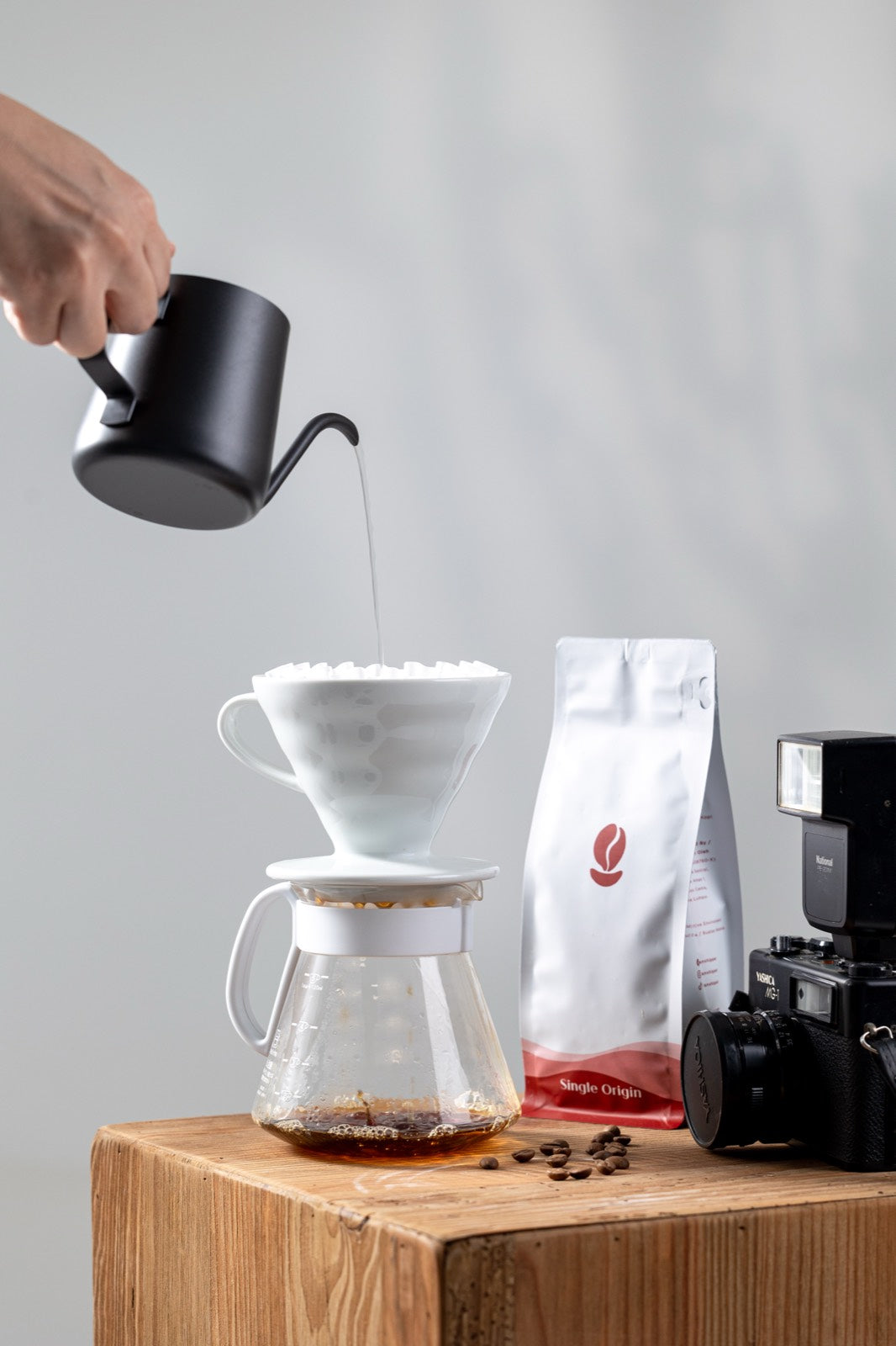Pour-over brewing beside a Bean Shipper bag