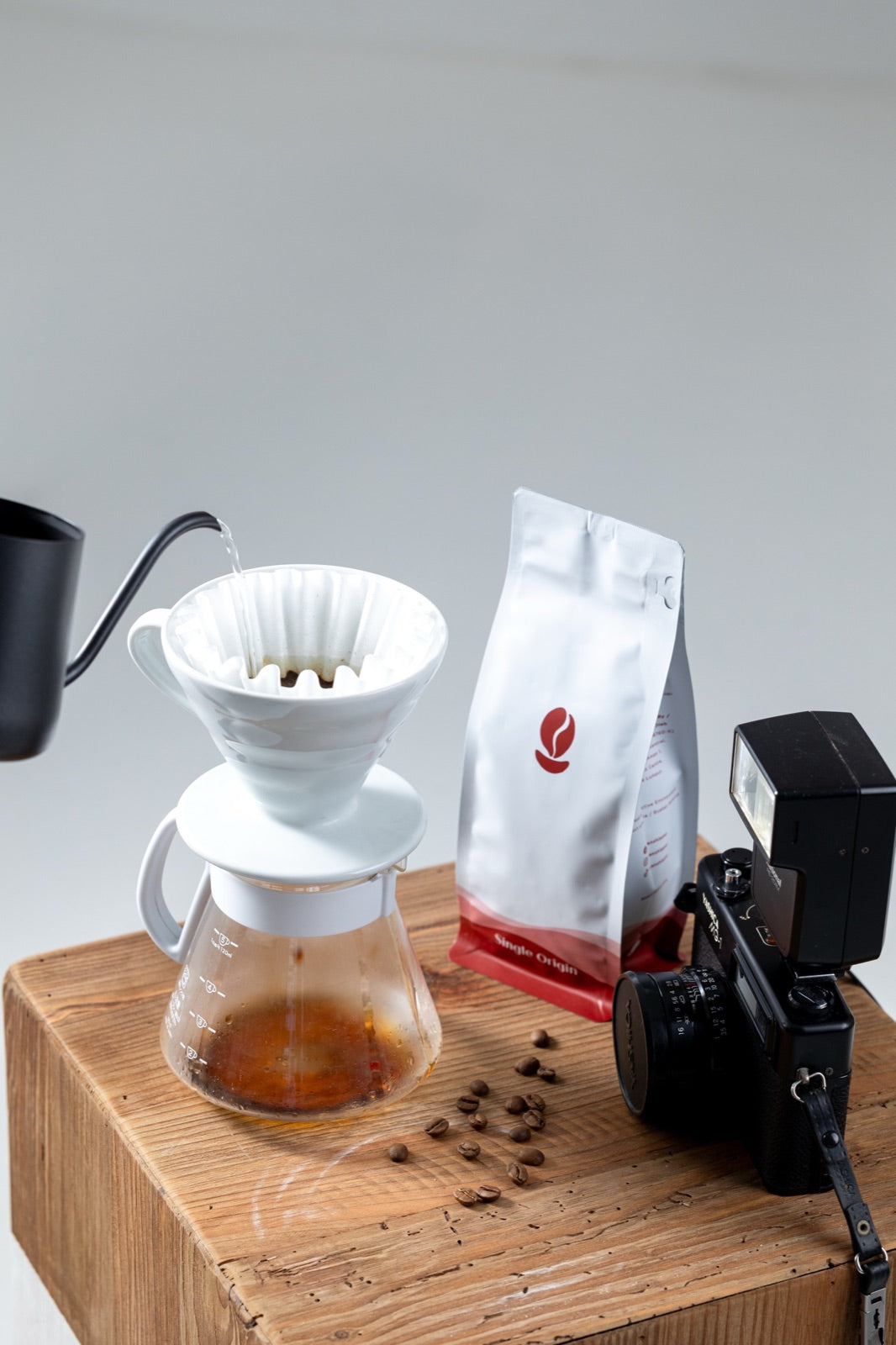 Pour-over brewing beside a white Bean Shipper bag